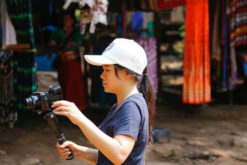 Obraz na płótnie Canvas vlogger with mirrorless camera and stabilizer