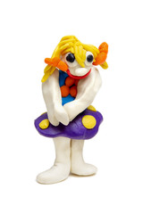 toy craft from plasticine. plasticine funny girl with yellow hair and blue skirt