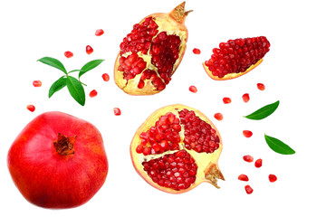 piece of pomegranate with seeds and green leaves isolated on a white background. top view