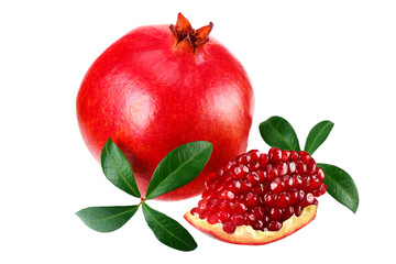 piece of pomegranate with seeds and green leaves isolated on a white background.