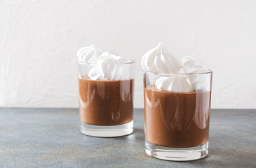 Delicious sweet dessert with chocolate and meringue. Chocolate mousse served in the glass cups