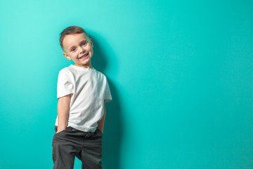 a model child posing on turquoise background