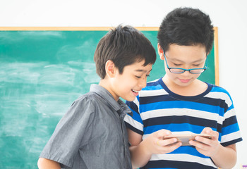 Asian students boy using laptop learning in the classroom at school