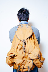 man with backpack, casual dressed, seen from behind, white background