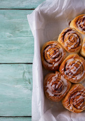 cinnamon rolls on wooden surface