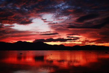 Fototapeta na wymiar Sunset over a lake amazing tonality of coloured reflection ideal place for camping