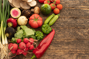 Several types of vegetables on the rustic wooden table.
