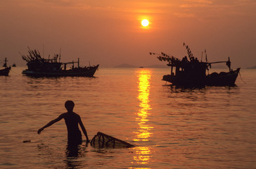 Fisherman with a cage trap at Ha Tien on Vietnams delta of river Mekong