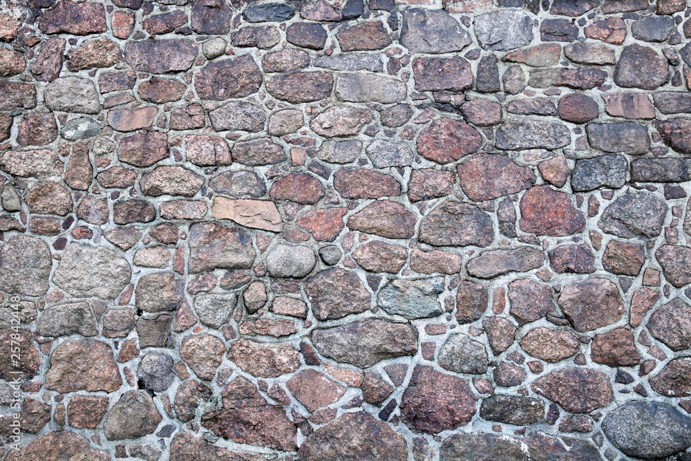 Poster  wall of granite cobblestones of different sizes