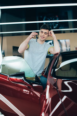 selective focus of happy man holding car keys while standing near new car