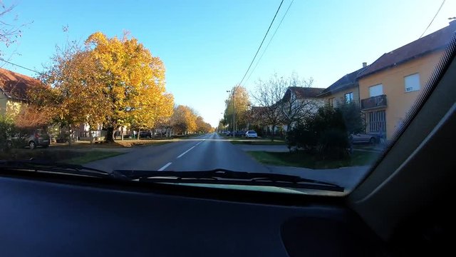 704 Long Car Drive On A Sunny Day Through Little Town And Stopping At Red Light