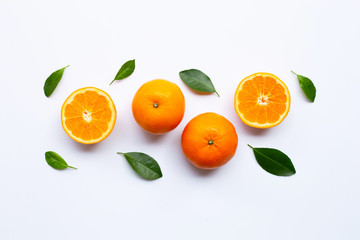 Fresh orange citrus fruits with leaves on white background.