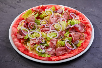 pizza with beef on the black background