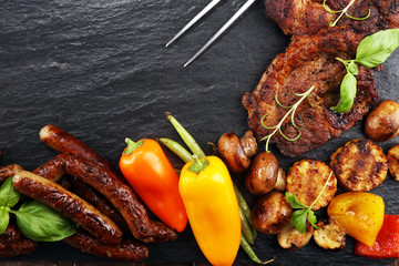 Assorted delicious grilled meat and skewer with vegetable on rustic table