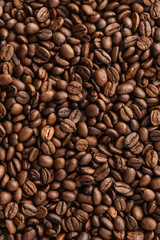 Roasted coffee beans background. Top view. Space for text.