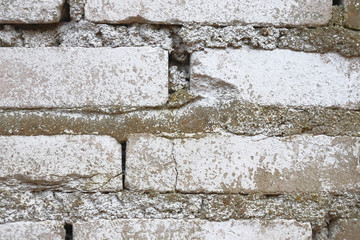 Old brickwork. Brick wall. White silicate brick. Crumbling brick from time to time.