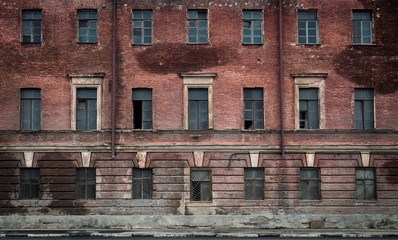 The wall with windows of the abandoned building