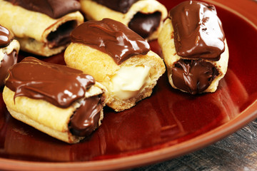 Traditional French dessert. Eclair with chocolate icing. Pastery concept with chocolate eclair