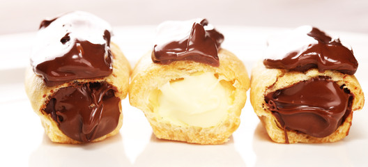 Traditional French dessert. Eclair with chocolate icing. Pastery concept with chocolate eclair