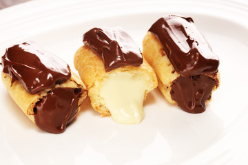 Traditional French dessert. Eclair with chocolate icing. Pastery concept with chocolate eclair