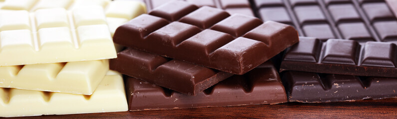 chocolate in diffrent color. milk, dark and white chocolate bars on table