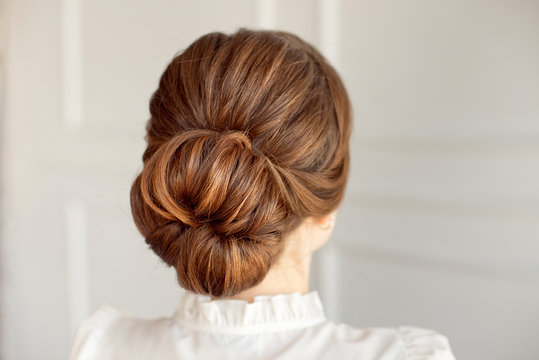 Rear View Of Female Hairstyle Medium Bun With Dark Hair.