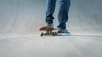 Skateboarder feet. Sport habit and active life. Urban lifestyle. Man on skateboard. Skate park ramp. Copy space.