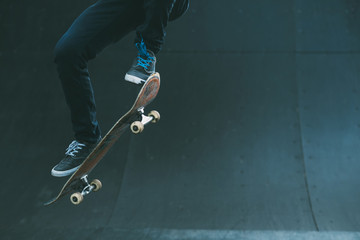 Urban skater in action. Ollie trick. Skate park ramp. City area. Man on skateboard jumping. Copy...