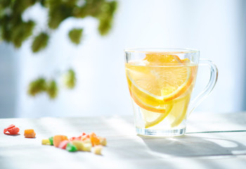 Orange-lemon drink in the gentle rays of the morning sun.