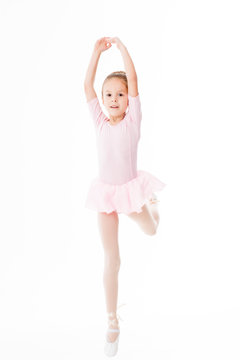 The little ballerina poses in a dancing dress