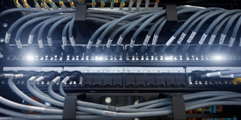 Network gigabit switch and UTP port cat 6 ethernet cables close-up