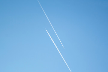 Two airplanes in the blue sky fly to the different ways. Creative concept of relationship. Paths diverged symbol.