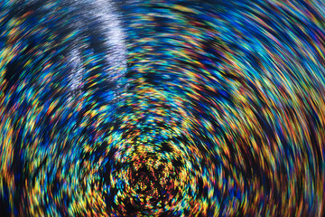 Obraz premium Neon lights on dark background. Whirling multicolor defocused lines. Lens flare. Blurred abstract background.