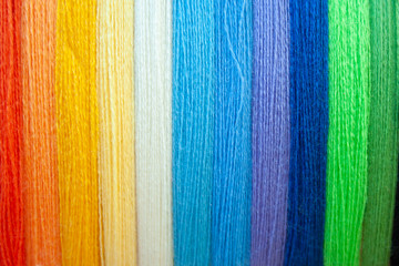 Many multi colored yarn strings for design background. Texture of colored thread. Concept of...