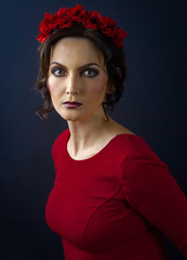 Woman in red dress and red flower crown.