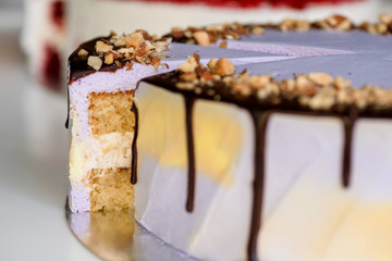 beautiful nut cake with purple mousse and red velvet cake. beautiful cut cake. close-up. purple icing