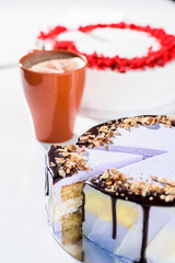 Red velvet cake and purple nut cake on a table with a cup.  beauty cake cut. top view. flat lay. close up 