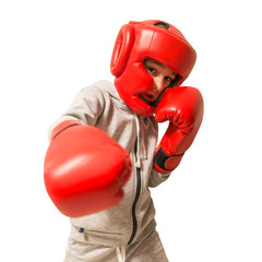 Young boy boxer practicing punches. Isolated on white background.