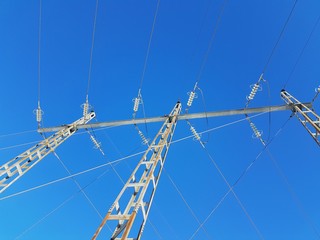 Power lines against a clear blue sky