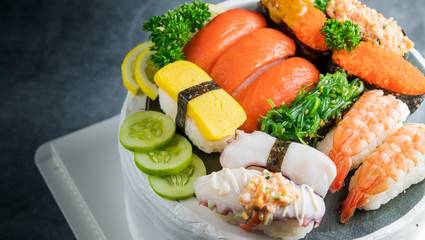 Japanese restaurant, sushi set on black slate plate top view, food concept background.