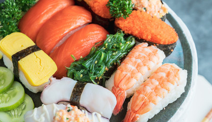 Japanese restaurant, sushi set on black slate plate top view, food concept background.