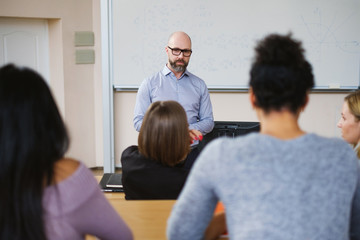 Lecturer and multinational group of students in an auditorium