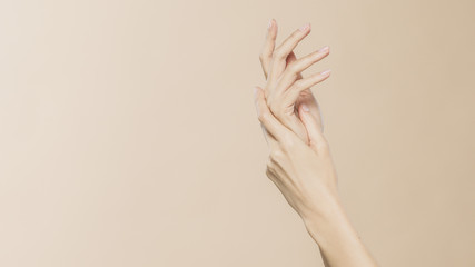 Women's hands on a beige background