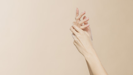 Women's hands on a beige background
