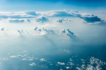 Top view of white clouds above the ground or water