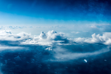 Top view of white clouds above the ground or water
