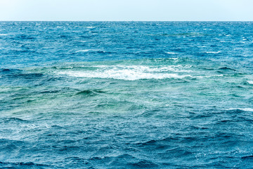 Fototapeta premium minimalistic seascape, blue sea and sky with white clouds on the whole frame