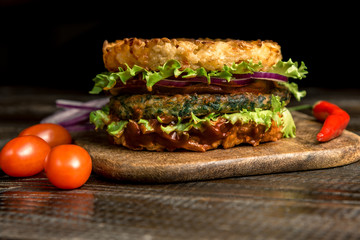Healthy lifestyle, proper nutrition. Healthy rice burger with vegetables, herbs and cutlet