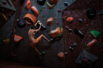 Athletic man practicing in a bouldering gym