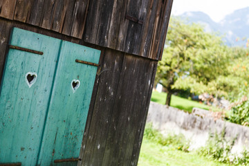 A window with hearts in an old house canted angle or oblique angle